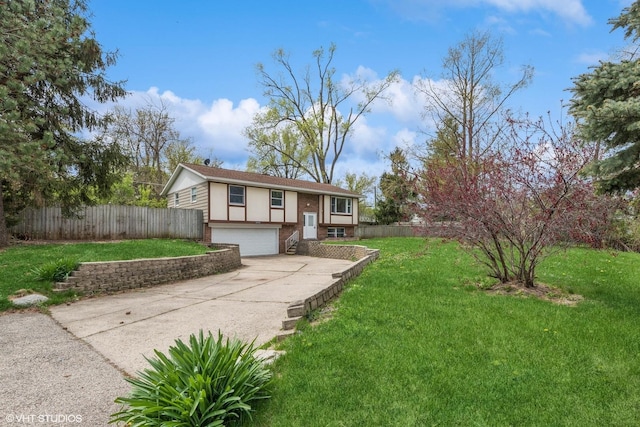 view of front of property with driveway, a front yard, brick siding, fence, and an attached garage