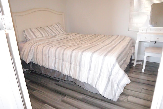 bedroom with wood finished floors