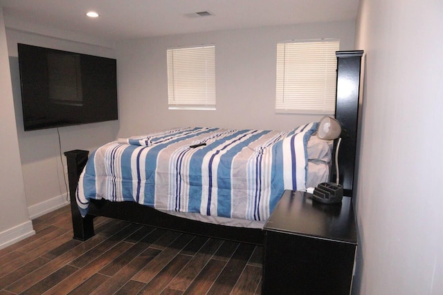 bedroom with recessed lighting, visible vents, baseboards, and wood finished floors