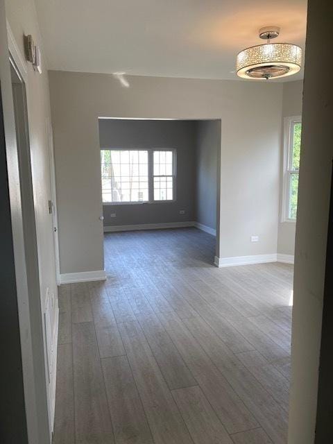 empty room with baseboards and wood finished floors
