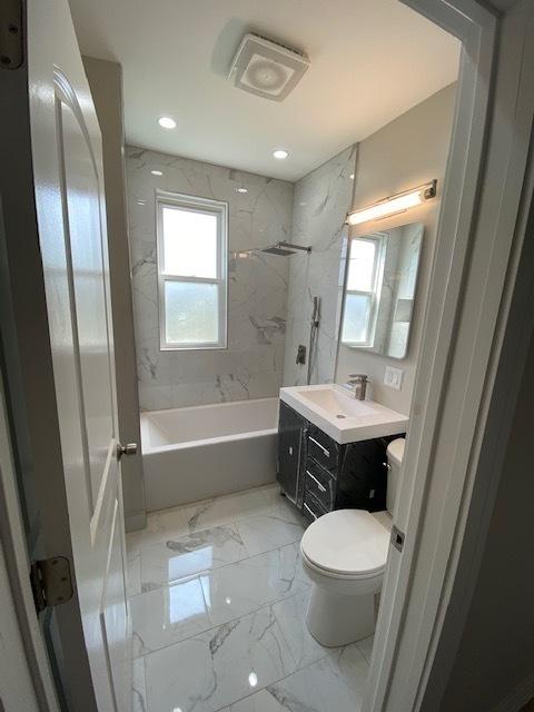 bathroom featuring vanity, recessed lighting, toilet, shower / bathtub combination, and marble finish floor