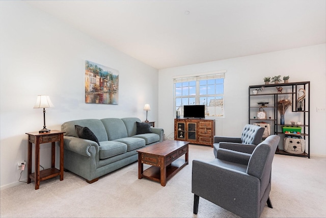 living room with baseboards and light colored carpet