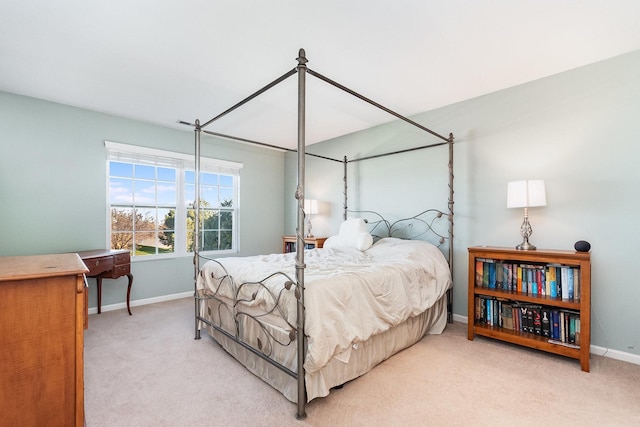 bedroom with baseboards and carpet