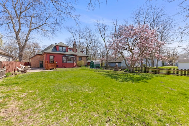 17864 Gladville Ave, Homewood, IL 60430 - view of yard with a fenced backyard, an outdoor structure, a patio, and a storage unit