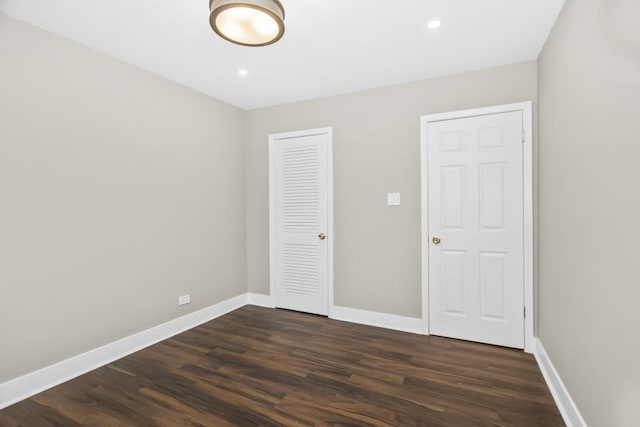 230 Dodge Ave Unit D, Evanston, IL 60202 - unfurnished bedroom with dark wood-style flooring, a closet, baseboards, and recessed lighting