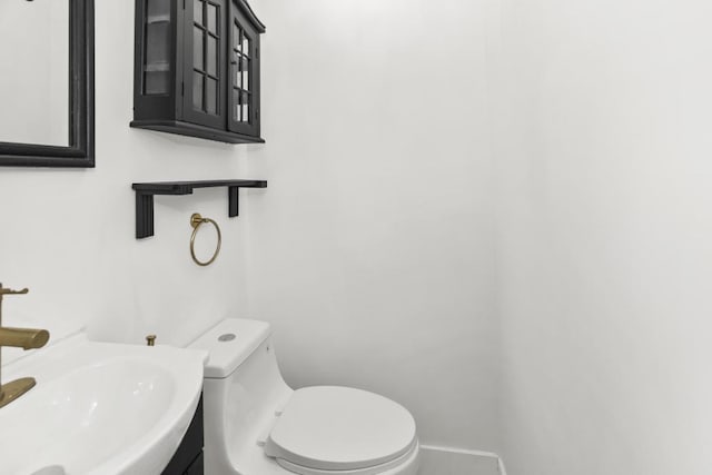 230 Dodge Ave Unit D, Evanston, IL 60202 - bathroom with baseboards, toilet, and a sink