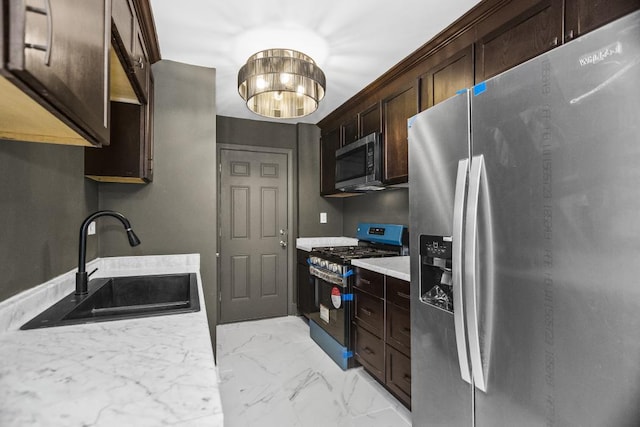 230 Dodge Ave Unit D, Evanston, IL 60202 - kitchen with light countertops, a sink, stainless steel appliances, marble finish floor, and dark brown cabinets