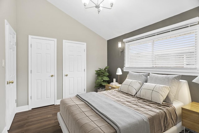 230 Dodge Ave Unit D, Evanston, IL 60202 - bedroom featuring baseboards, lofted ceiling, wood finished floors, and an inviting chandelier