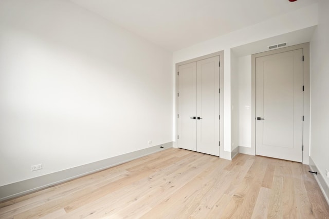 1548 W Ardmore Ave Unit 2F, Chicago, IL 60660 - unfurnished bedroom featuring light wood-style floors and a closet