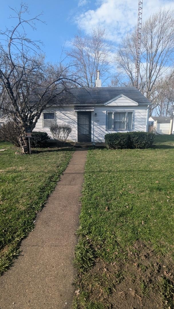 617 Woodlawn Ave, Mattoon, IL 61938 - view of front of property with a front yard and a chimney