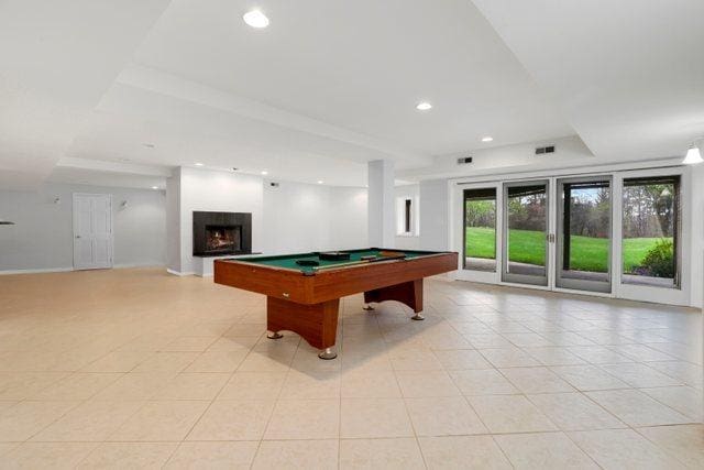 playroom featuring recessed lighting, light tile patterned floors, billiards, and a warm lit fireplace