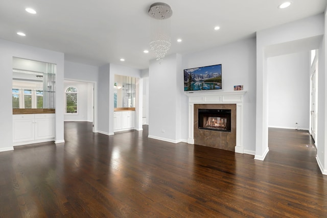unfurnished living room featuring recessed lighting, wood finished floors, and a fireplace
