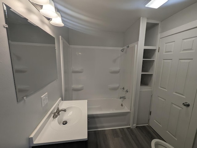 full bath with vanity, washtub / shower combination, and wood finished floors