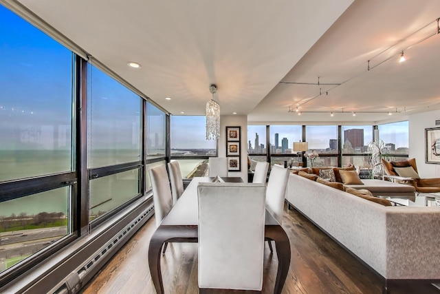 sunroom / solarium with rail lighting and a view of city