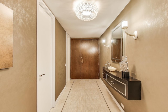 doorway to outside with light tile patterned floors