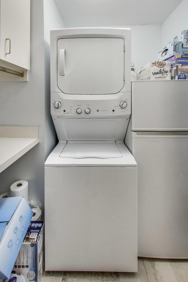clothes washing area featuring stacked washer / dryer