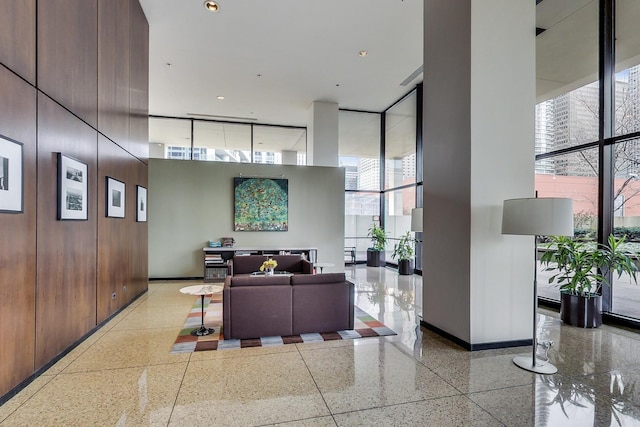 community lobby with floor to ceiling windows and a towering ceiling