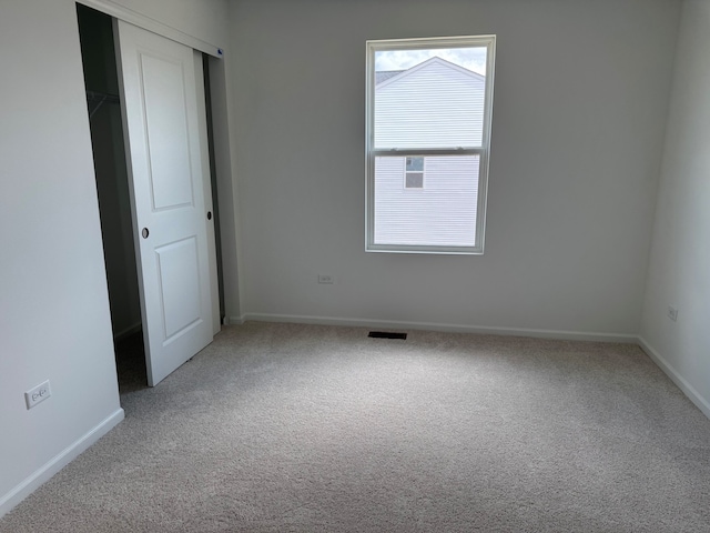 640 Henry Ln, Oswego, IL 60543 - unfurnished bedroom featuring carpet flooring, baseboards, and a closet