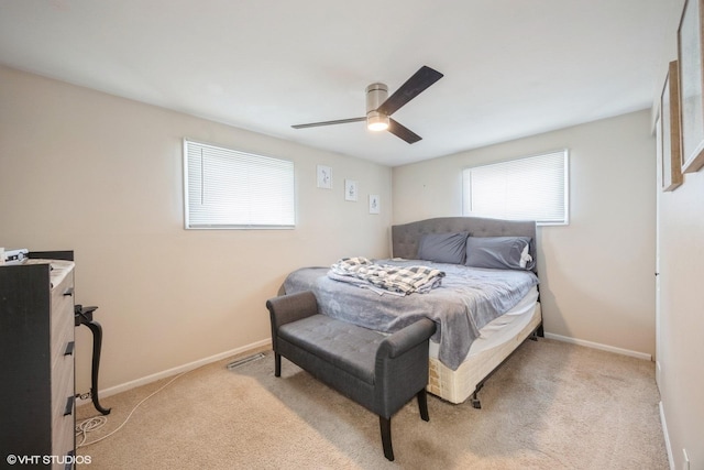 bedroom featuring baseboards, a ceiling fan, and light colored carpet