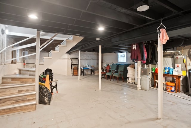 below grade area featuring gas water heater and stairs