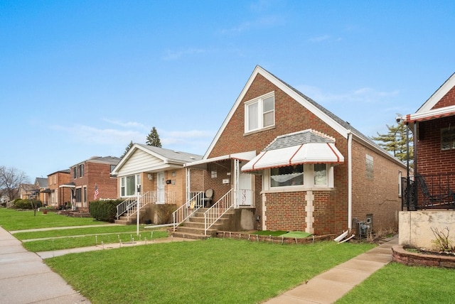 view of front facade featuring brick siding and a front yard