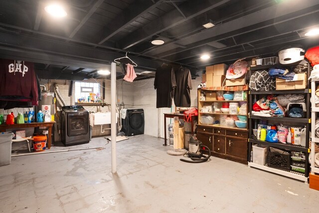 unfinished below grade area featuring washing machine and dryer and water heater