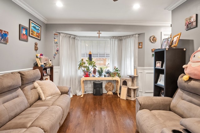 living area with recessed lighting, wood finished floors, a decorative wall, wainscoting, and ornamental molding