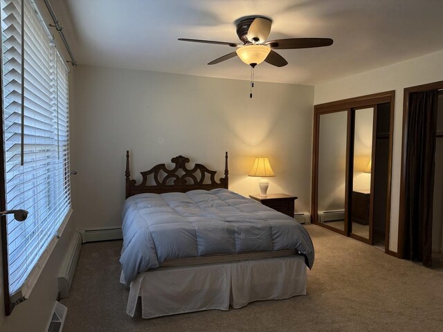 bedroom featuring baseboard heating, a ceiling fan, and carpet flooring