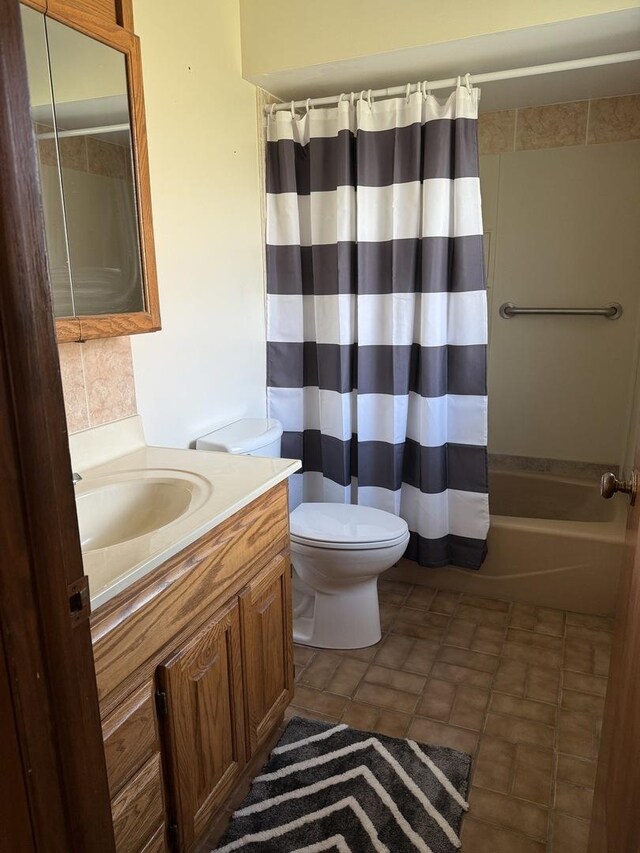 bathroom with baseboard heating, baseboards, vanity, and ensuite bath