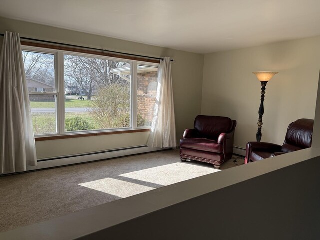 unfurnished living room featuring a stone fireplace, carpet flooring, ceiling fan, and baseboards