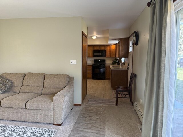 unfurnished living room featuring a stone fireplace, carpet flooring, ceiling fan, and baseboards