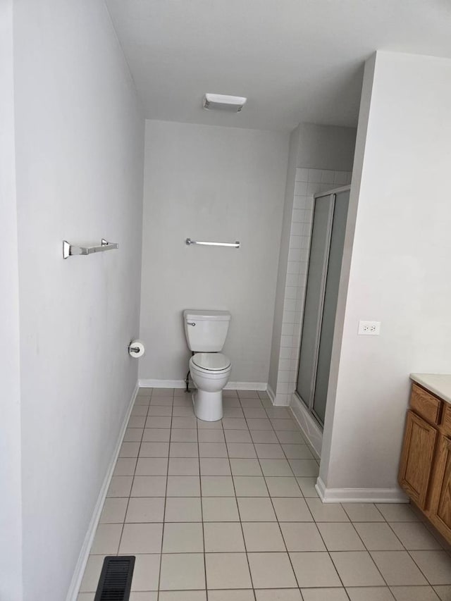 full bathroom featuring visible vents, toilet, vanity, tile patterned floors, and a stall shower