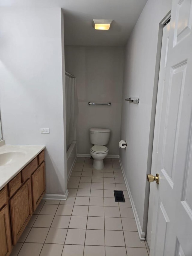 bathroom with vanity, baseboards, tile patterned flooring, toilet, and visible vents
