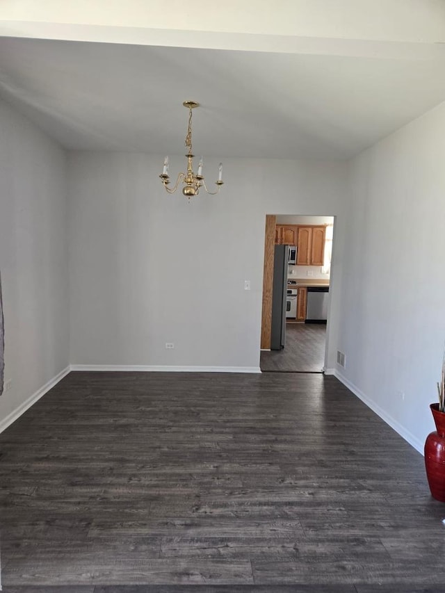 unfurnished dining area with visible vents, a notable chandelier, dark wood-style floors, and baseboards