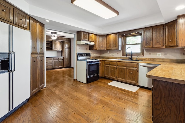 19049 S Parker Rd, Mokena, IL 60448 - kitchen with white fridge with ice dispenser, stove, dishwasher, under cabinet range hood, and a raised ceiling