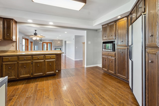 19049 S Parker Rd, Mokena, IL 60448 - kitchen with freestanding refrigerator, a peninsula, dark wood-style floors, a ceiling fan, and recessed lighting