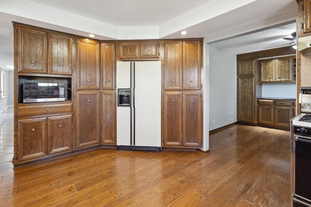 19049 S Parker Rd, Mokena, IL 60448 - kitchen with white refrigerator with ice dispenser, stainless steel microwave, recessed lighting, range, and brown cabinets