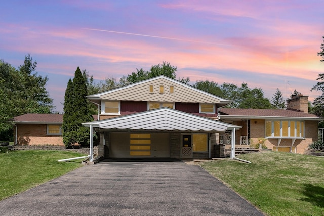 129 Roth Ave, Barrington, IL 60010 - tri-level home featuring asphalt driveway, a yard, a carport, and brick siding