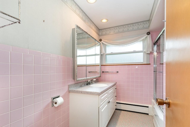 129 Roth Ave, Barrington, IL 60010 - full bath with a baseboard heating unit, tile walls, vanity, shower / bath combination with glass door, and tile patterned flooring