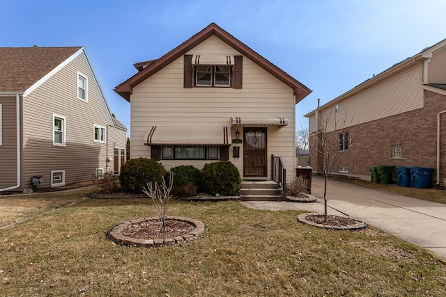 view of front of property with driveway and a front lawn