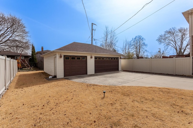 detached garage featuring fence