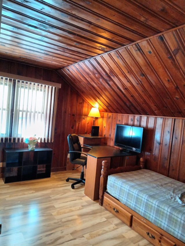 bedroom featuring vaulted ceiling, wooden ceiling, wood walls, and light wood finished floors