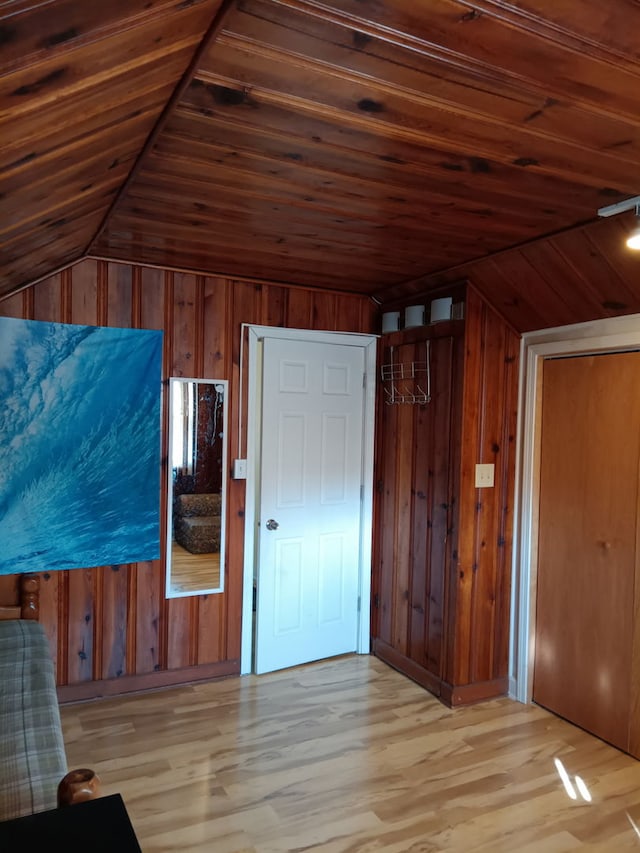 bonus room with wood ceiling, wooden walls, vaulted ceiling, and wood finished floors