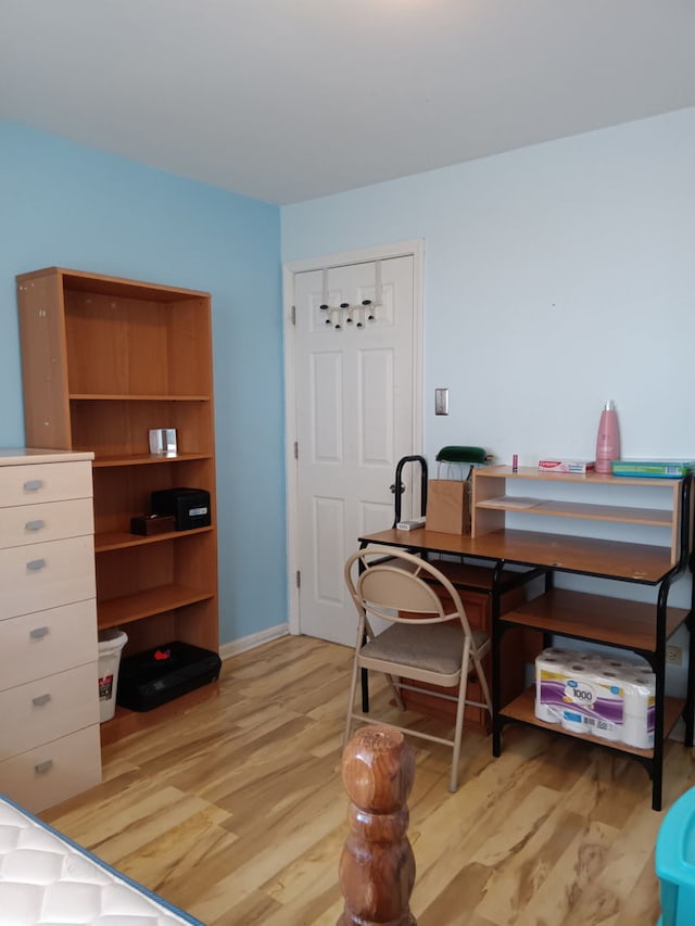 home office with baseboards and light wood-style floors