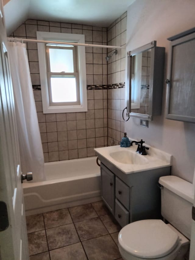 bathroom with toilet, vanity, tile patterned floors, and shower / bath combo