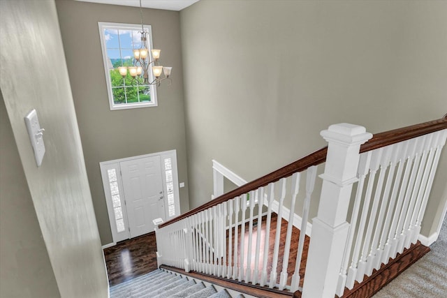 entryway with a chandelier and baseboards