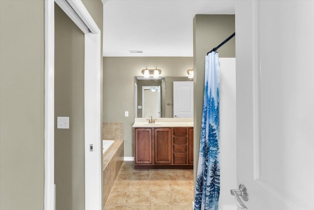full bathroom featuring tiled bath, vanity, and a shower with shower curtain