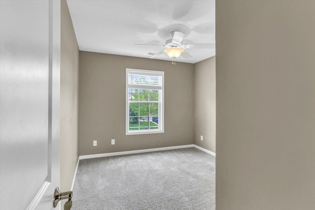 carpeted empty room featuring baseboards and ceiling fan