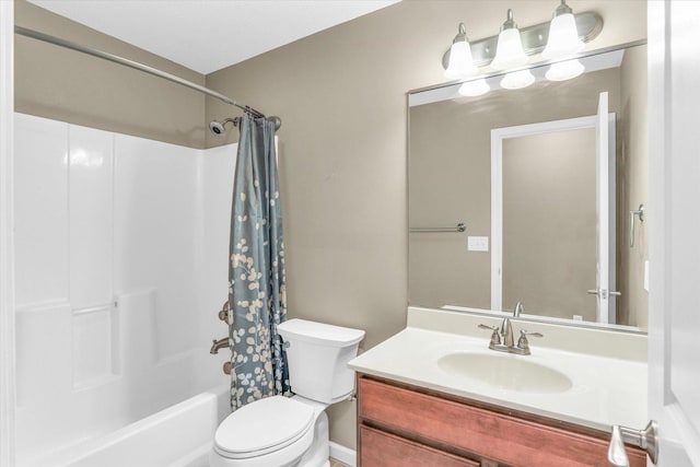 bathroom featuring toilet, vanity, and shower / bath combo with shower curtain