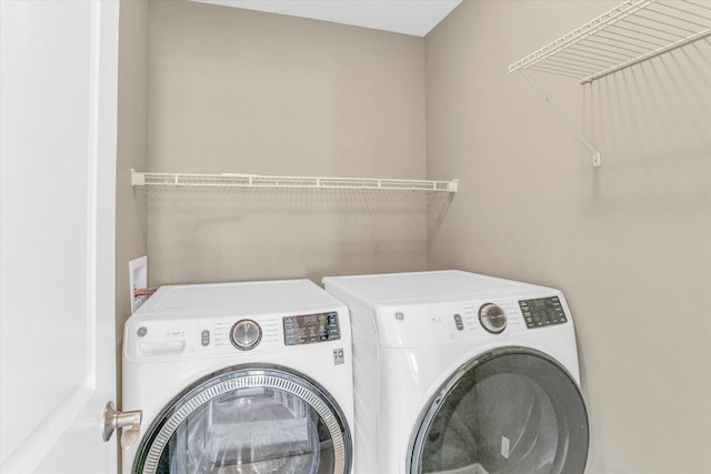 laundry area with separate washer and dryer